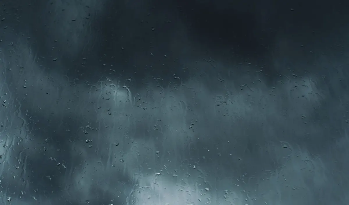 Storm rain against a window during hurricane season in South Florida