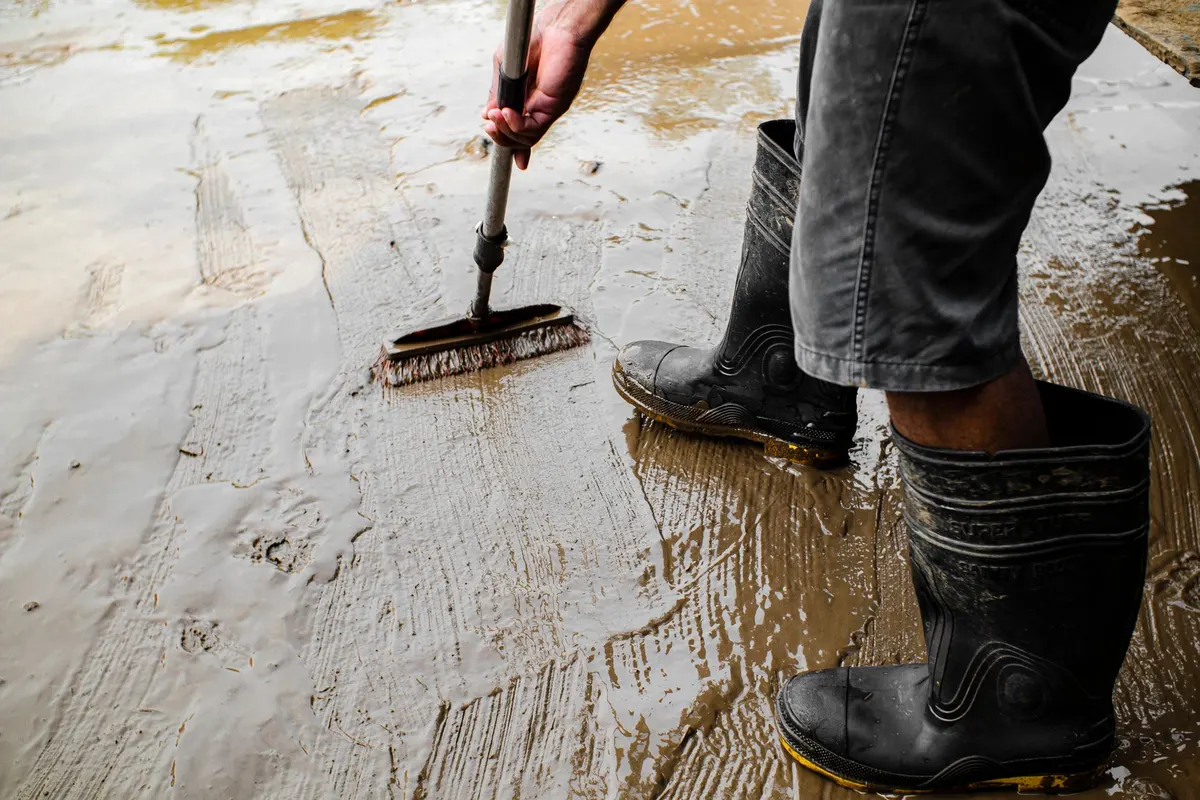 Technician working on a wet floor during water damage restoration